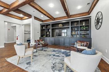 A living room with a white couch and a wooden ceiling.